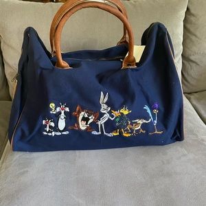 Warner Brothers, canvas, cotton duffel with leather straps, and trim.